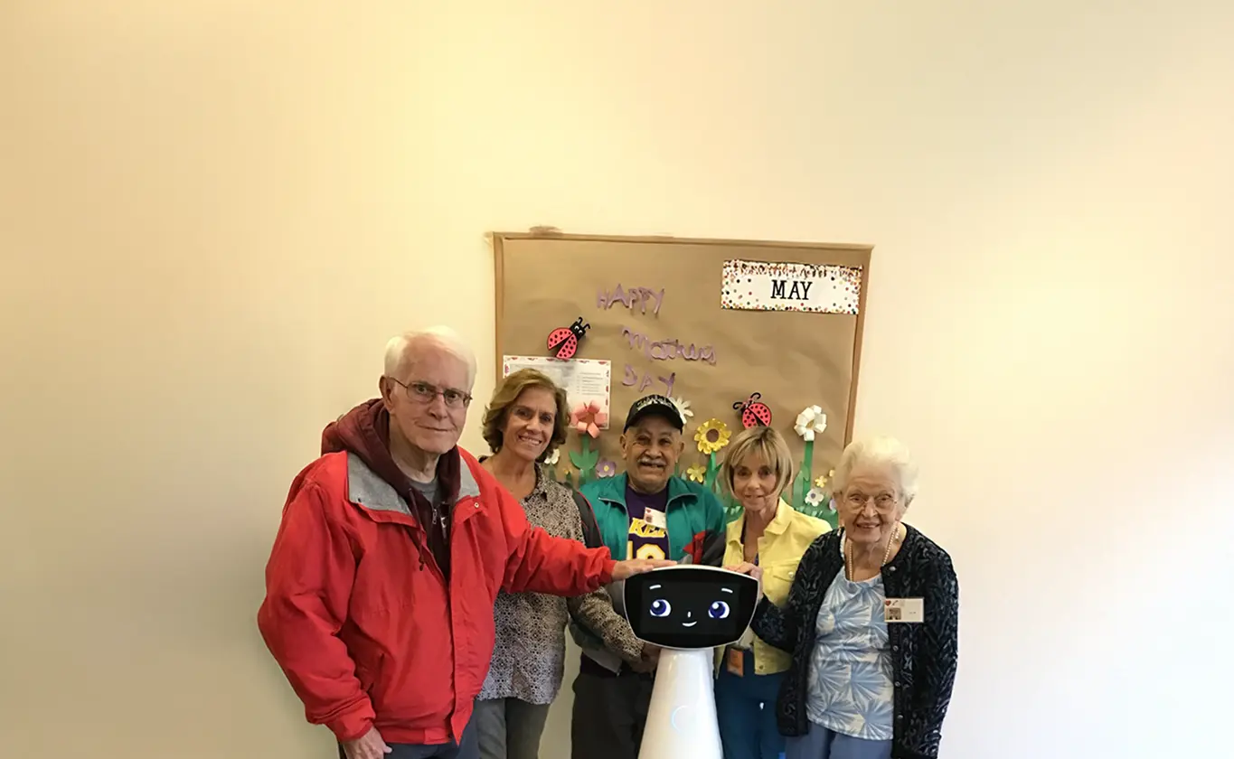 Robin with an elder at a facility