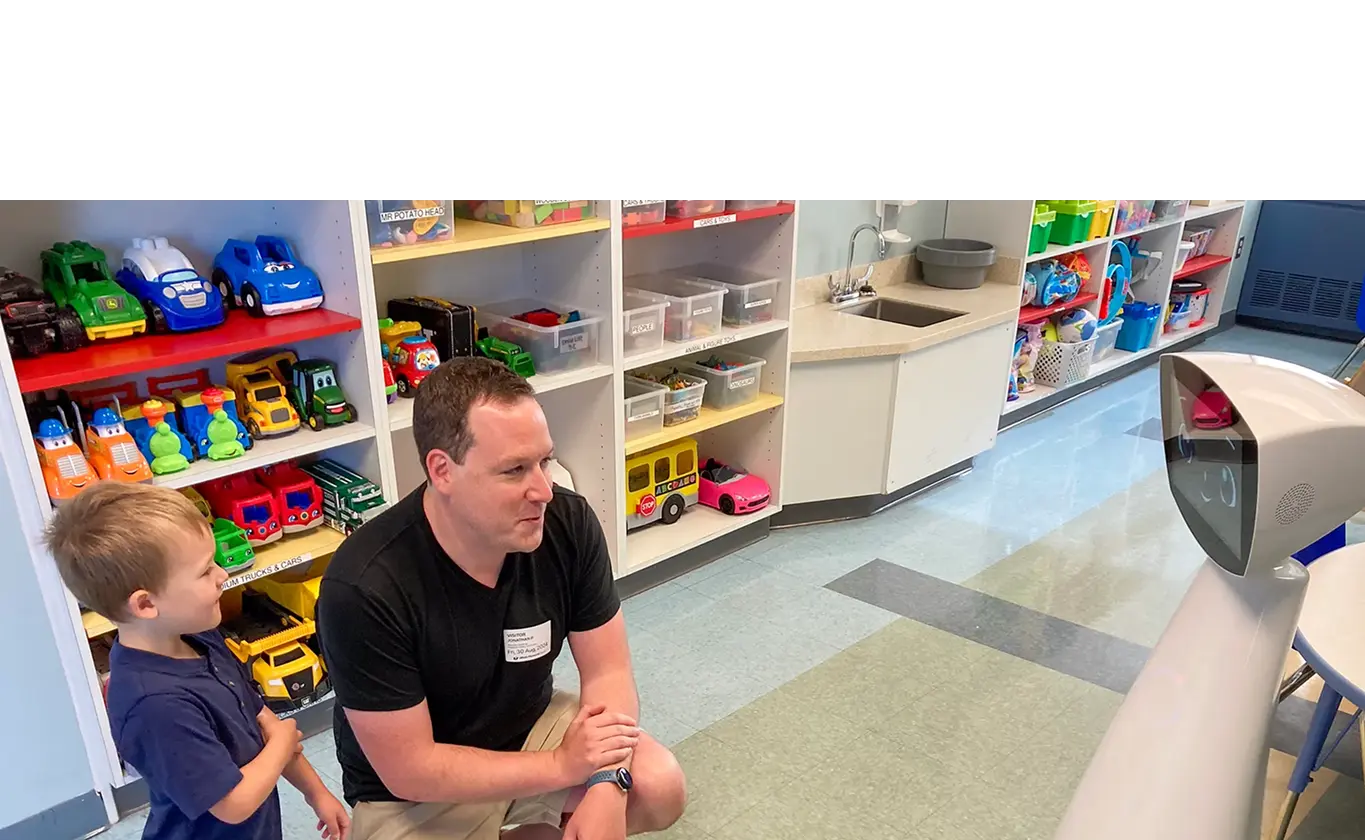 Robin with an elder at a facility